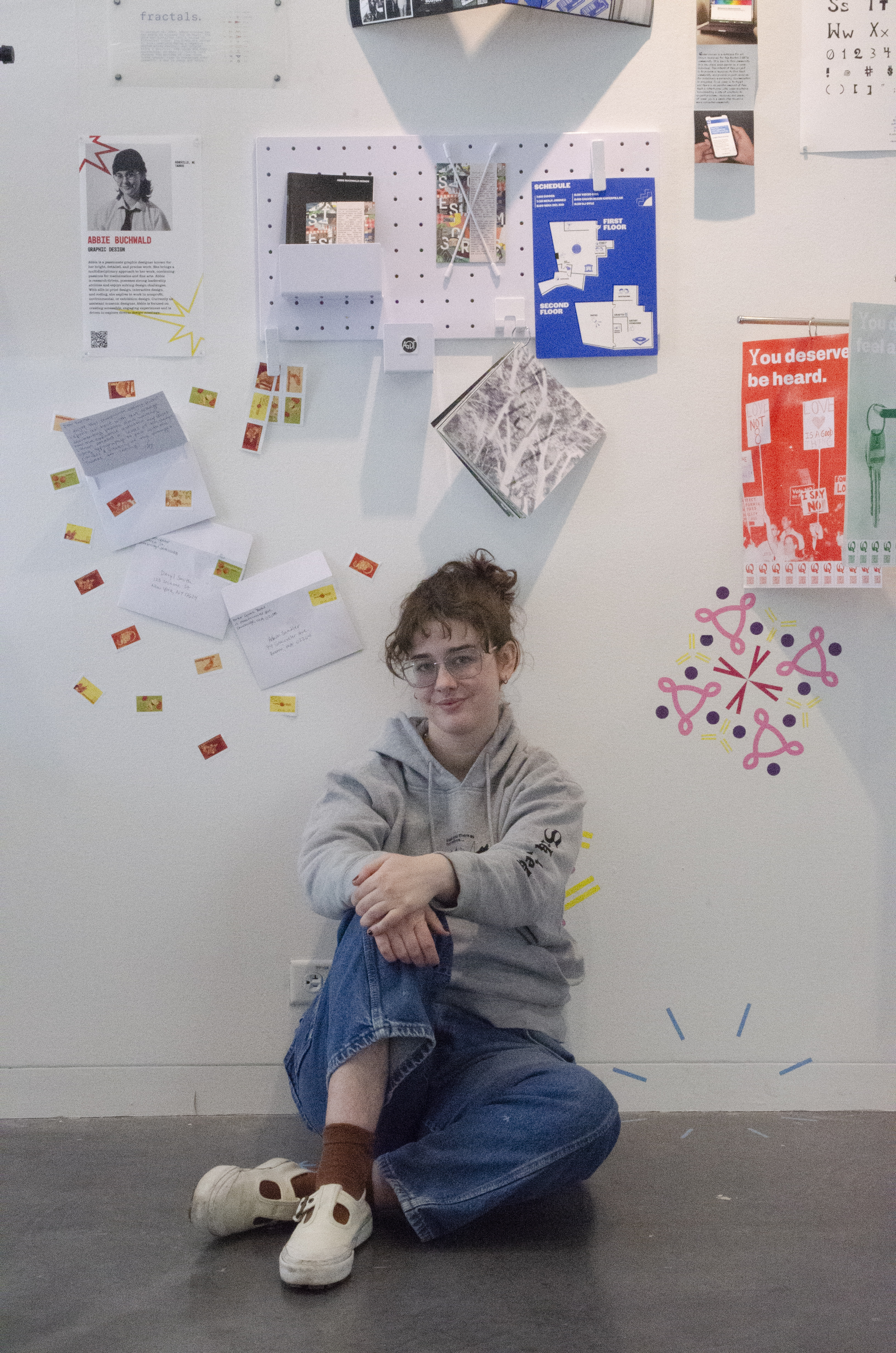 Abbie sitting in front of an exhibition space